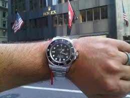 Man Wearing a Rolex Watch in Front of a Rolex Store in New York City